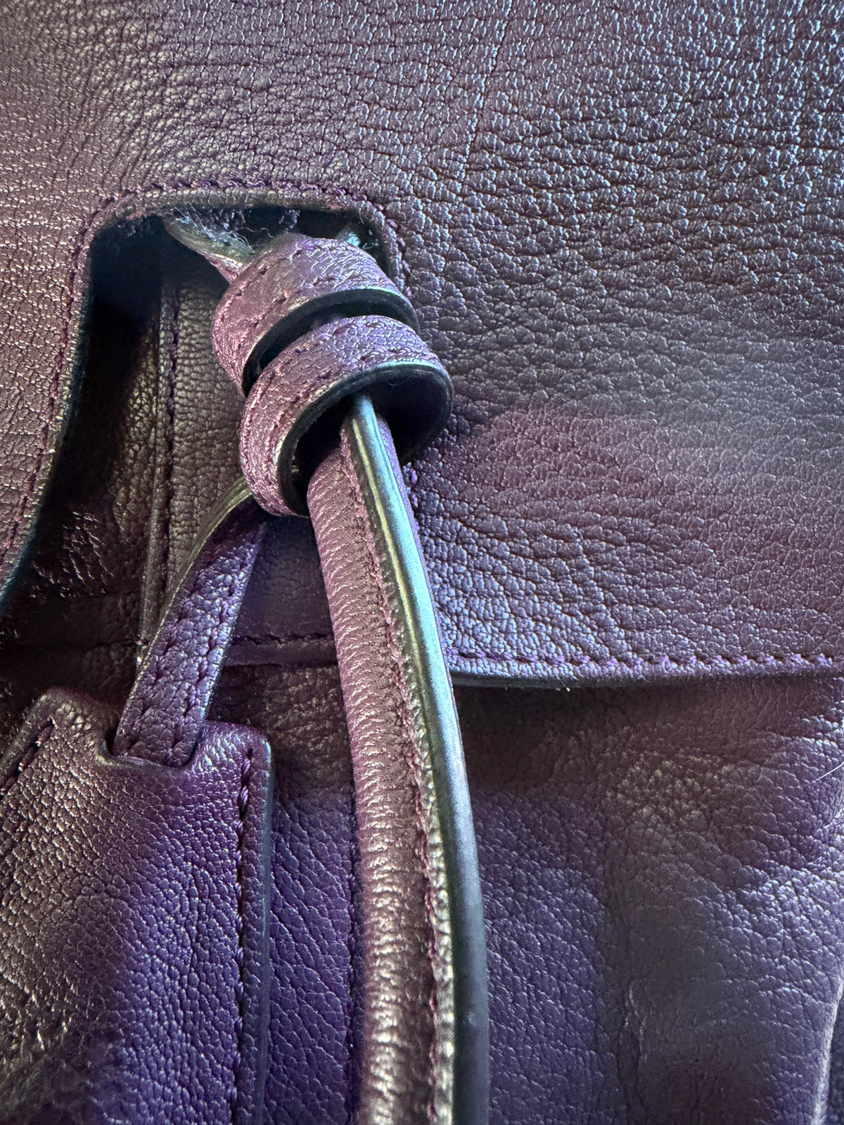 Close-up of a brown Mulberry leather handbag showing textured grain, stitching and a gold-tone turnlock.
