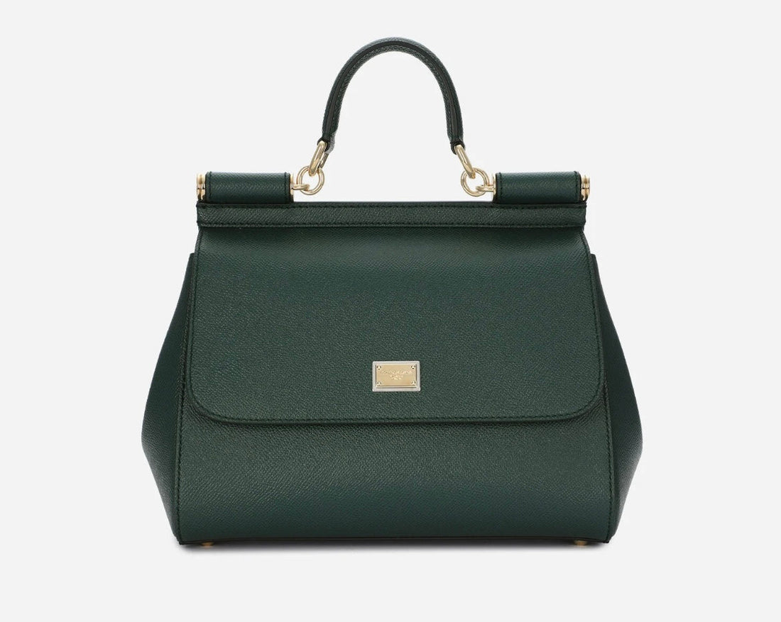 Large Dolce & Gabbana Sicily bag in dark green textured calfskin, with a top handle, front flap and gold-tone hardware against a pale background.